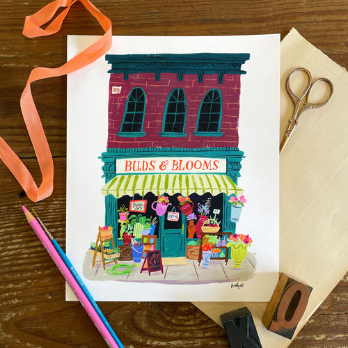 Illustration of a vintage flower shop storefront with colorful flowers displayed and a striped awning. Hand lettering reads Buds and Blooms