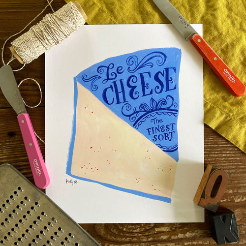 Illustration of a large wedge of creamy pink cheese with bright blue label. Victorian style hand lettering reads Le Cheese: The Finest Sort