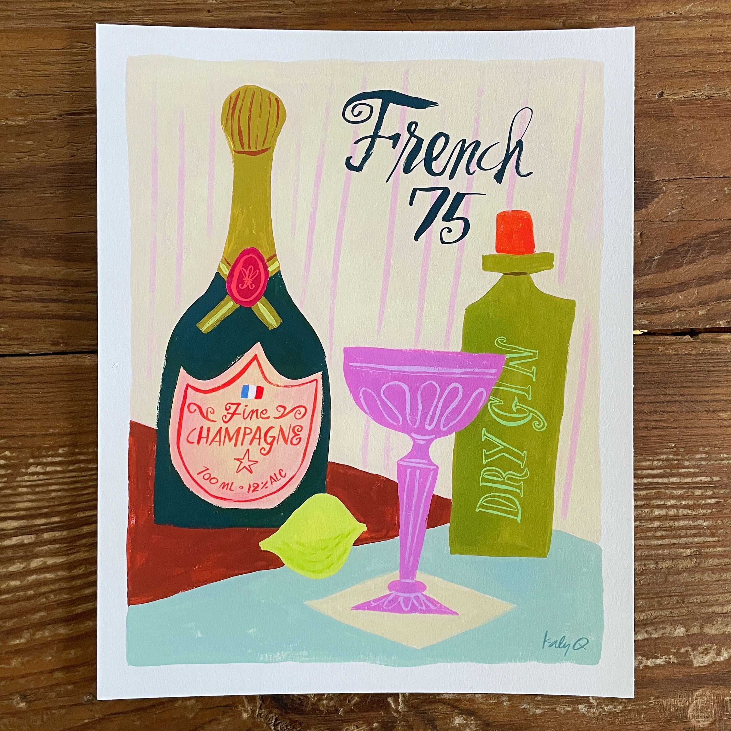 Illustration of a French 75 cocktail in a pink coupe glass with champagne and gin bottles, brush hand lettering reads French 75