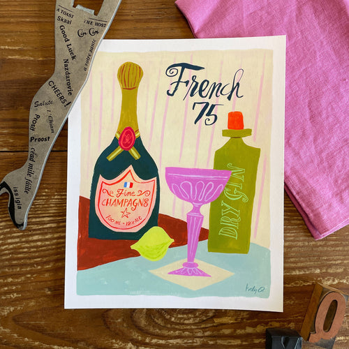 Illustration of a French 75 cocktail in a pink coupe glass with champagne and gin bottles, brush hand lettering reads French 75
